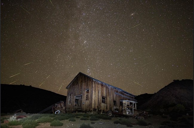 Wooden structure surrounded by starry night sky