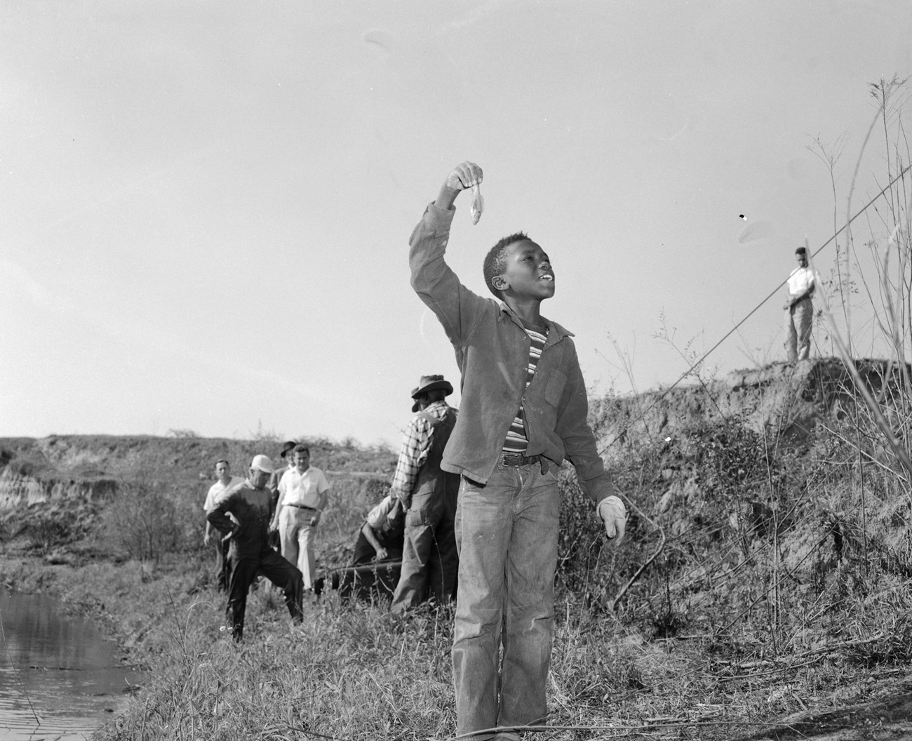 Boy holding a small fish