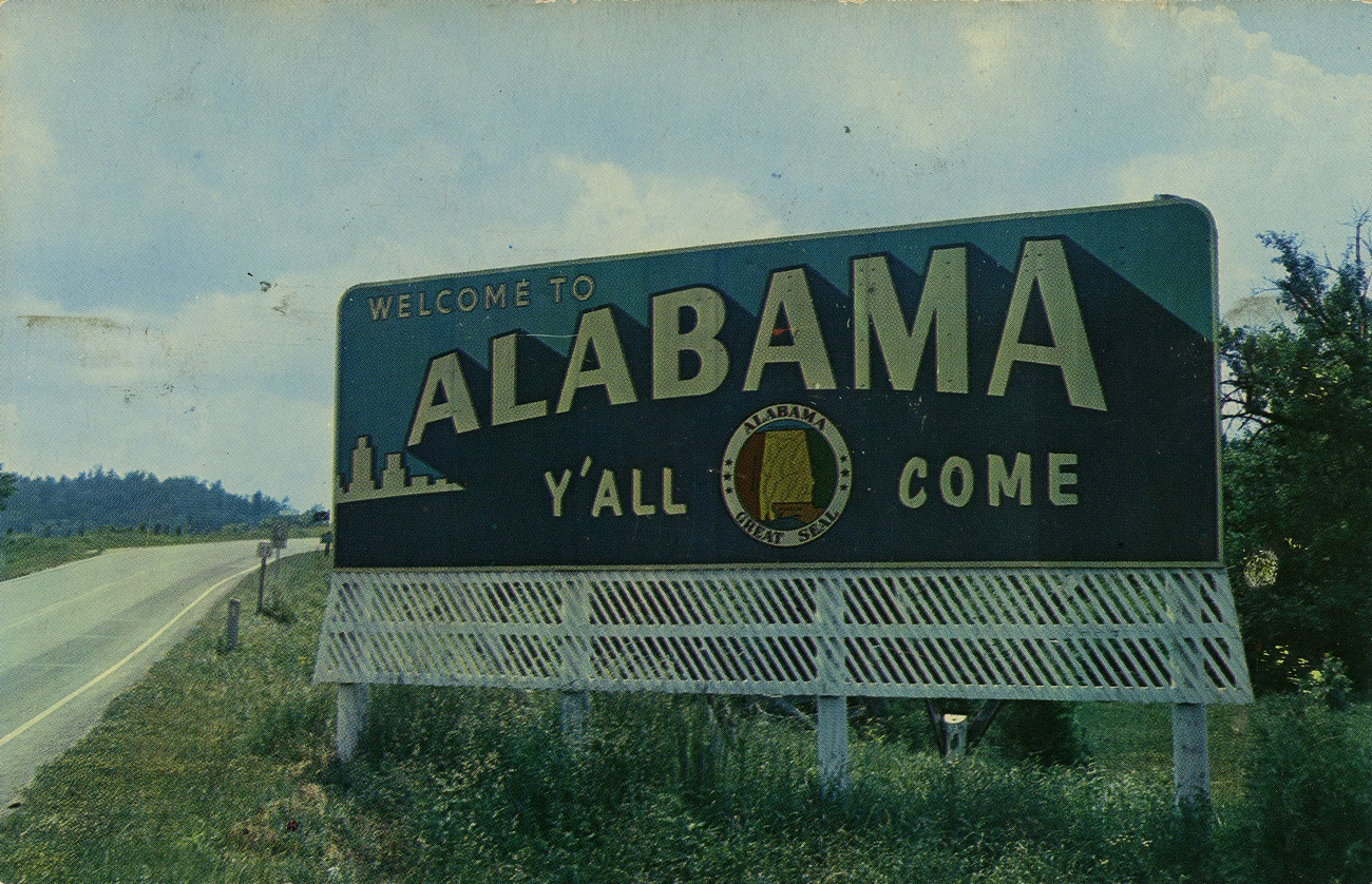 A highway sign that says "Alabama Y'all Come" A highway sign that says "Alabama Y'all Come"