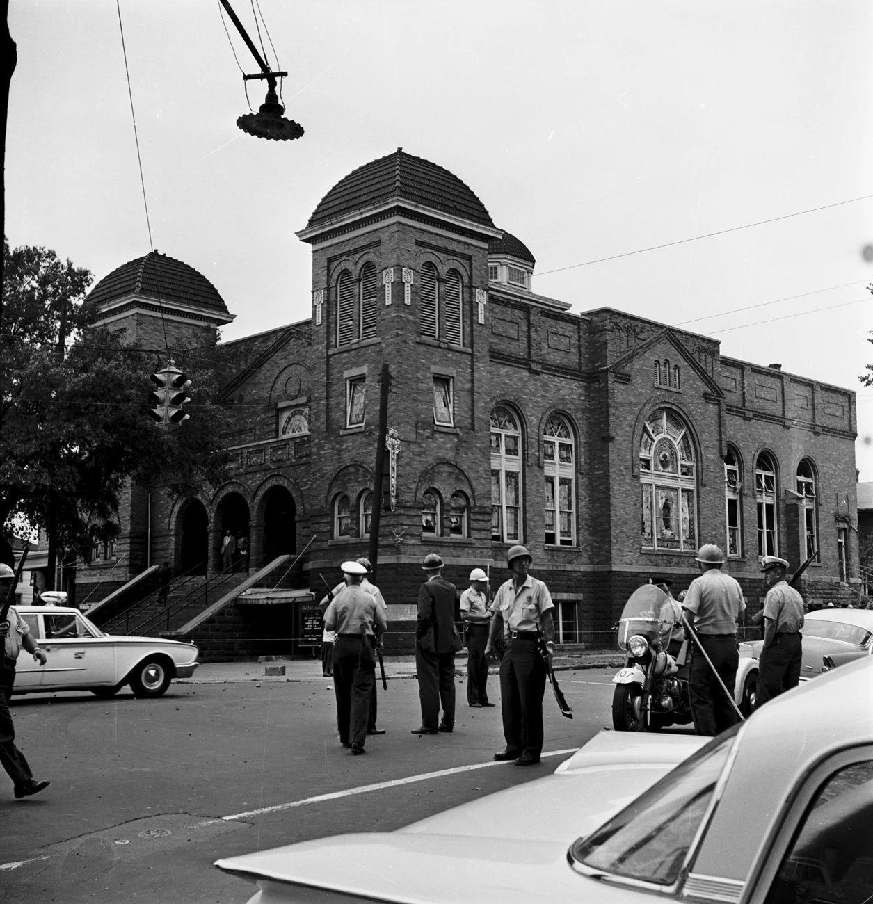 Police officers on guard outside 16th Street Baptist Church. Debris is scattered in the streets. Police officers on guard outside 16th Street Baptist Church. Debris is scattered in the streets.