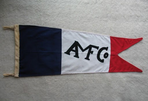 red, white, and blue flag with AMFCo logo