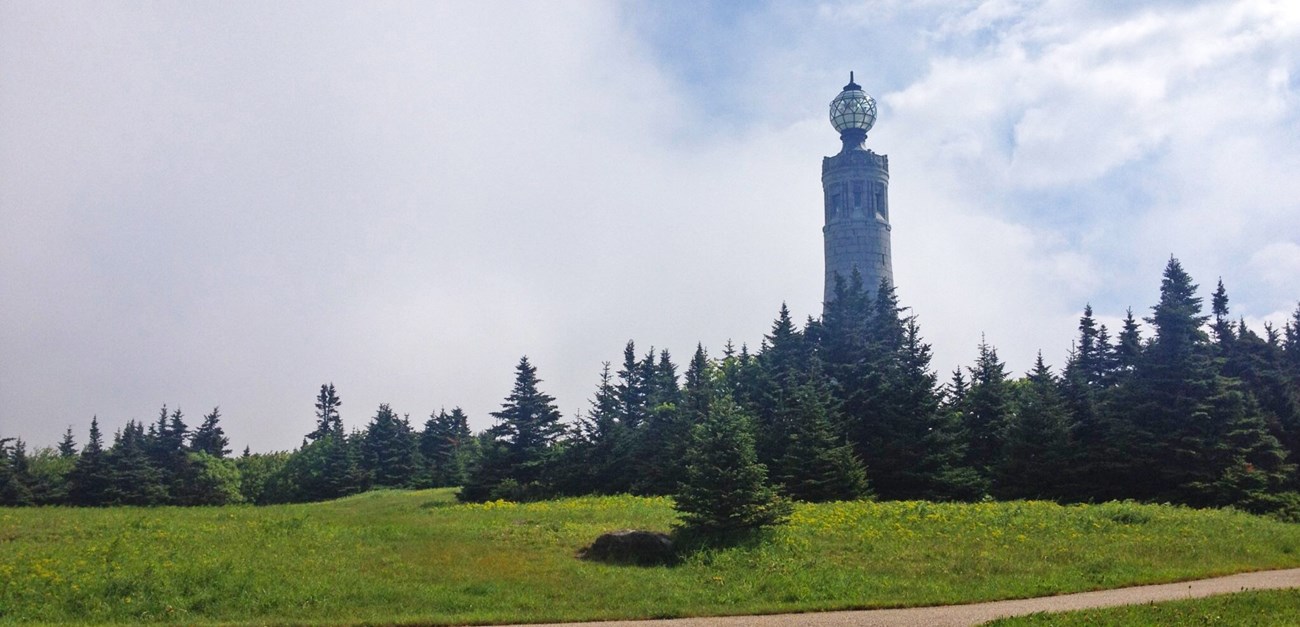 Memorial tower in a green field