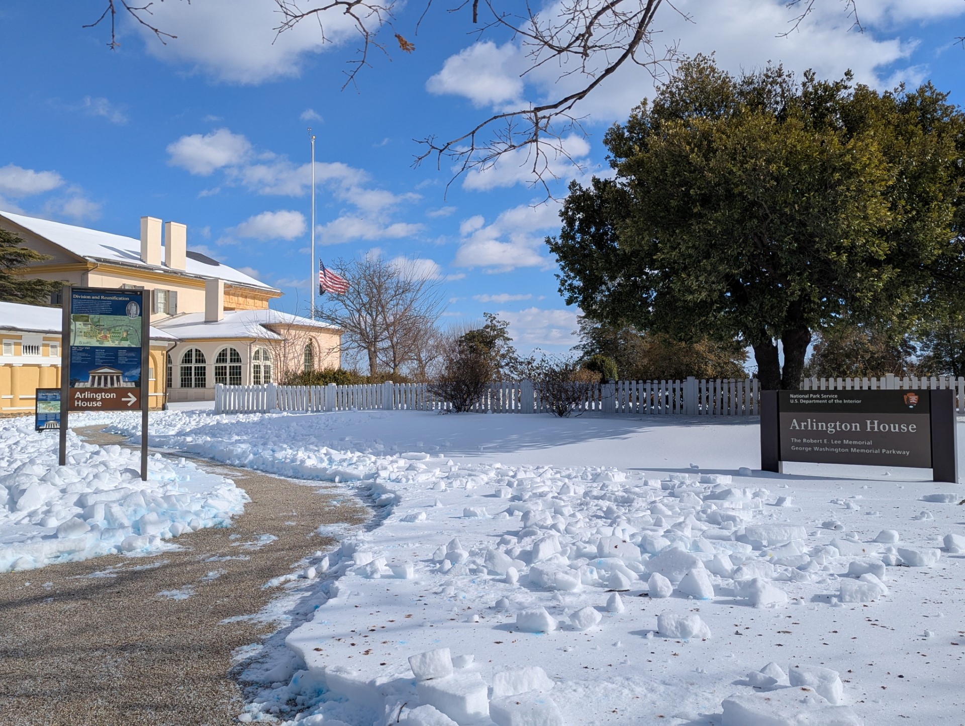 A shoveled sidewalk leads to the snow-covered Arlington House