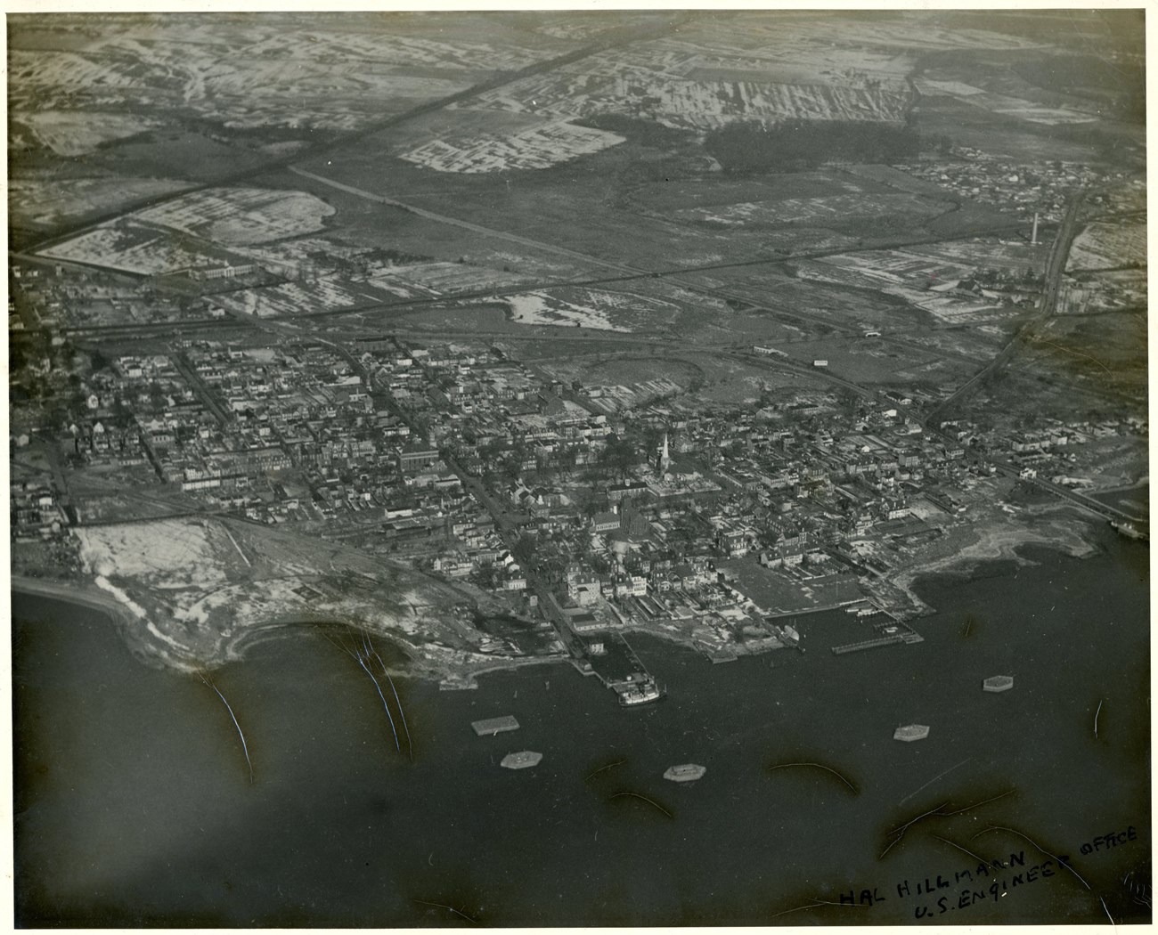 Aerial Photo of colonial town with past of the coastline at the bottom.