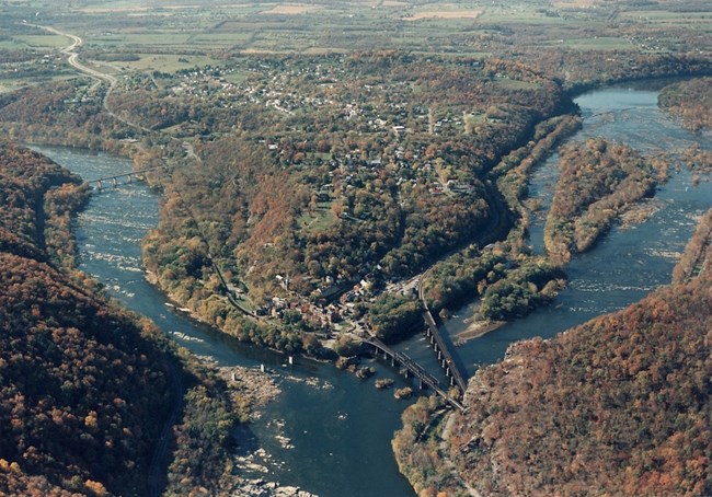 Aerial view of Harpers Ferry Two rivers coming together, surrounded by wooded land.