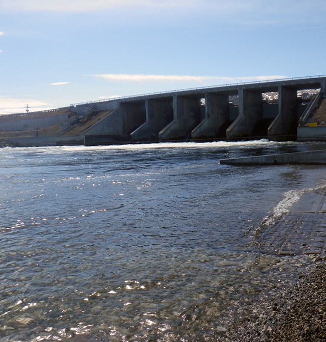 An afterbay dam and flowing river water