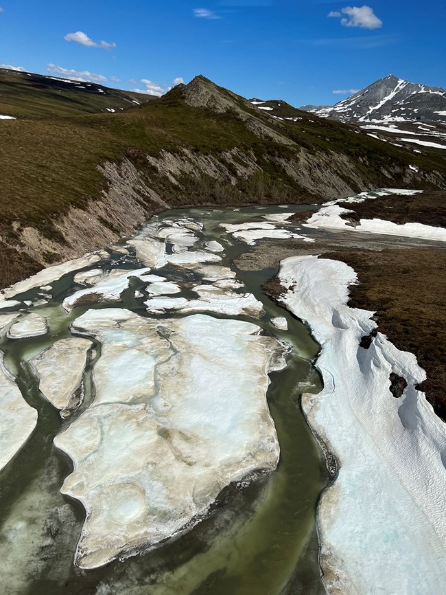 Agashashok_SFM1_June2022_web A stream with melting snow and ice.