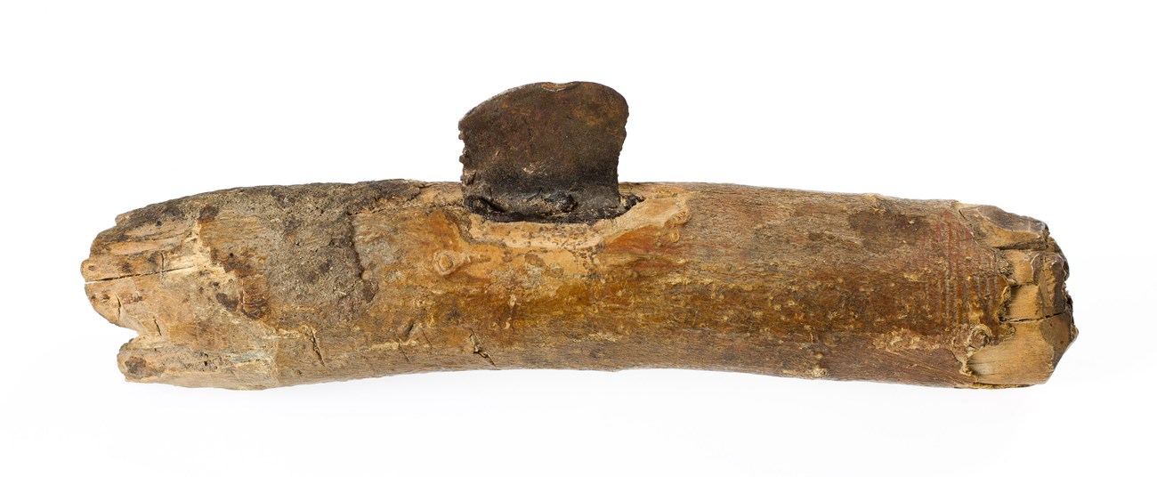 Wooden handle with blade in center made of stone