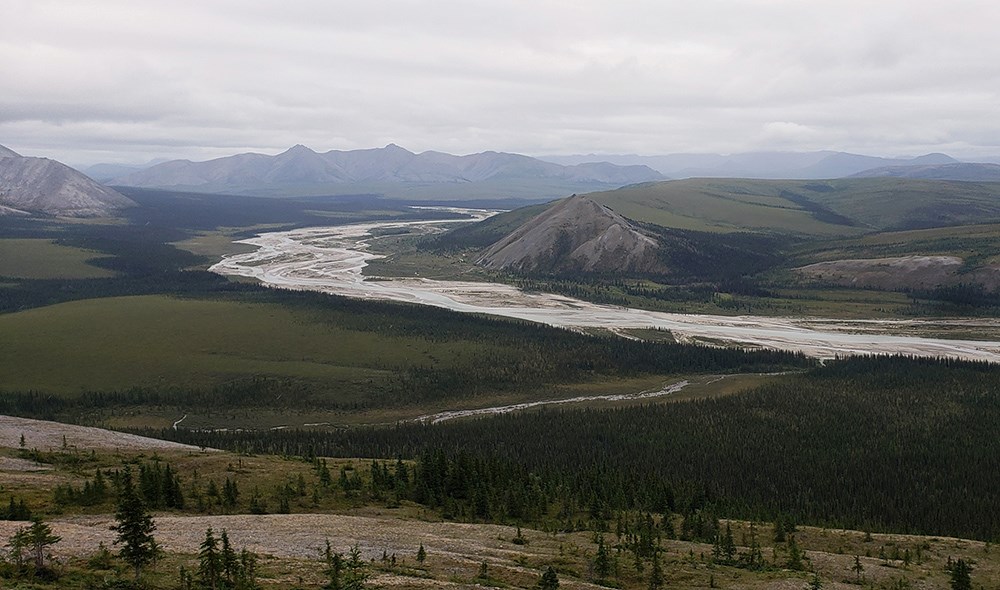 Aggie_Luby_web A river valley surrounded by mountains and forest.
