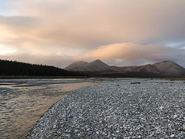 Aggie_web An Arctic stream, gravel beach, and mountains in the background.