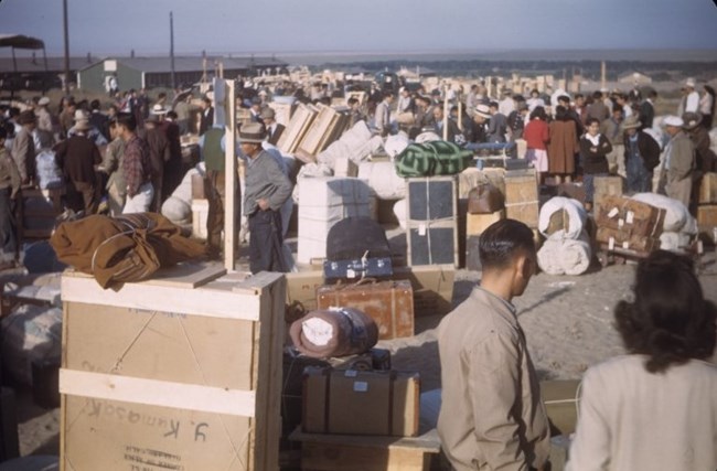 Arrival of Japanese American incarcerees Dozens of new Japanese Americans enter the Granada Relocation Center with wooden crates and luggage