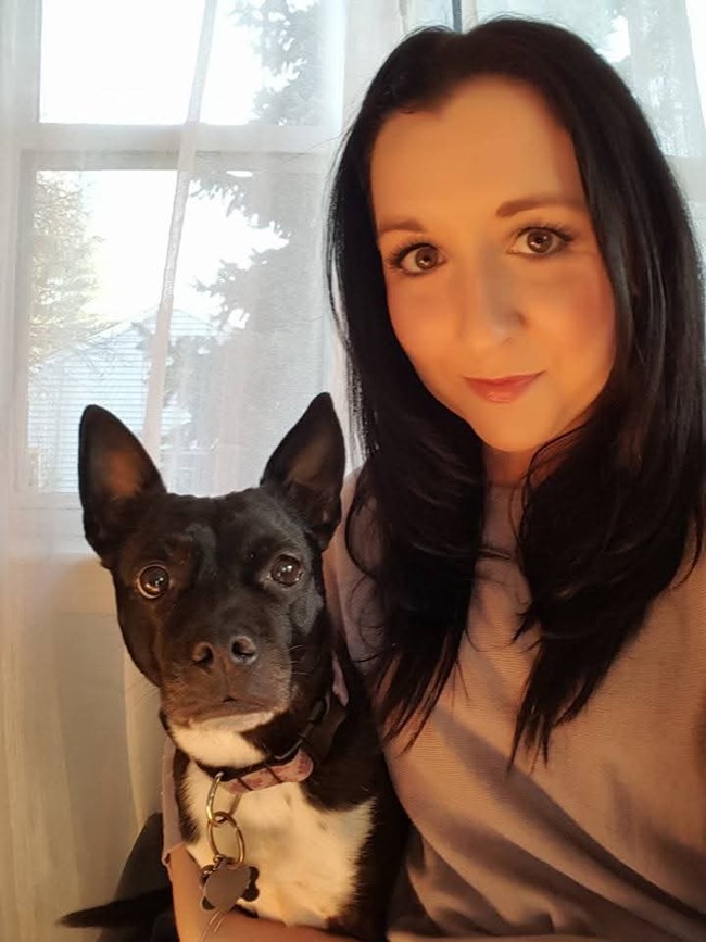 A person and her dog take a selfie.