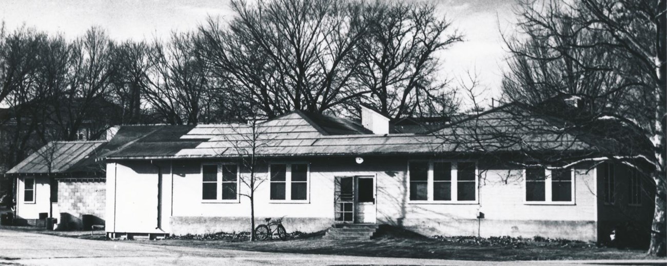 Little Ankeny at Ames Black and white photo of a small one-story building.