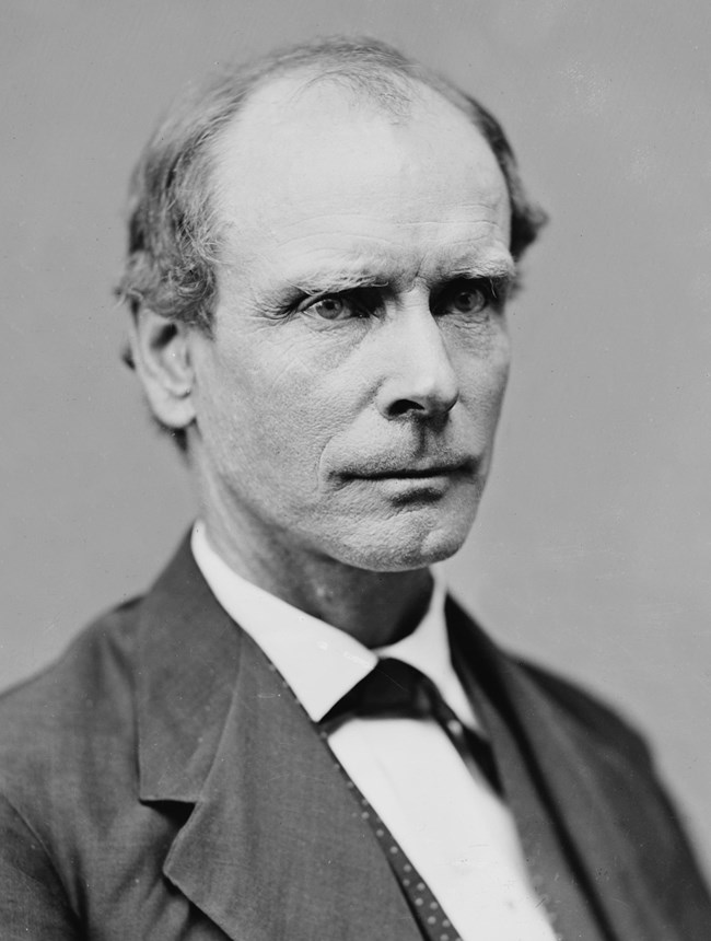 Amos T. Akerman man with thinning hair wearing suit and posing for a photo.