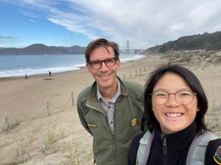 A woman and male smiling outdoors