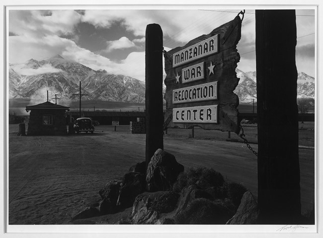 Ansel Adams entrance sign black and white photo of Manzanar sign