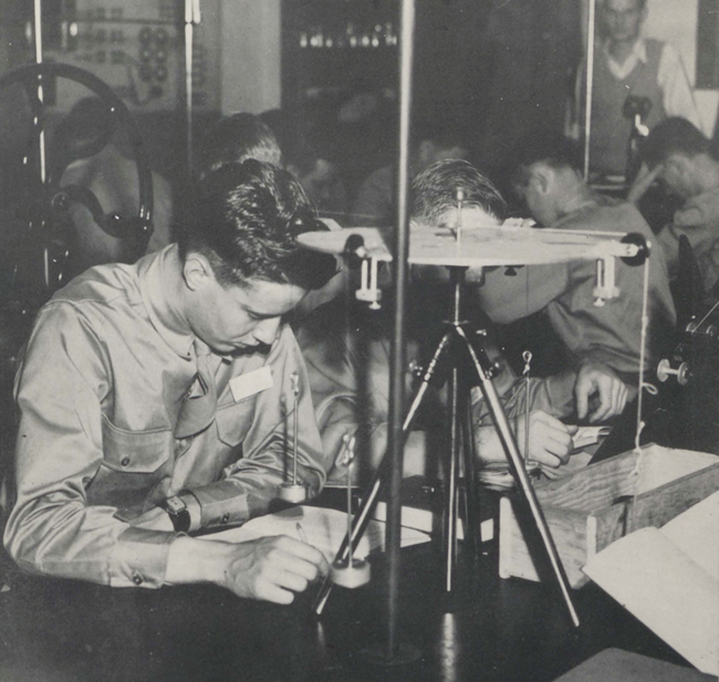 Army aviation students in class Black and white photograph of military students at desks, studying.