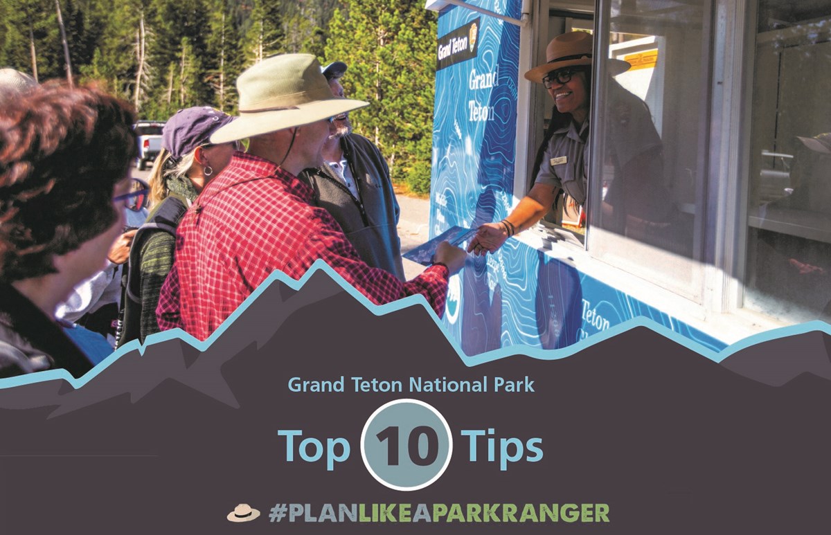 Ranger helps park visitors plan their adventure Park ranger provides map and information for visitors to plan their adventure