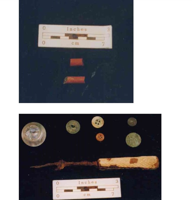 Image of red African beads, multicolored buttons, and a white knife with rust.