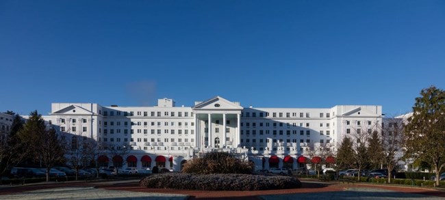 Ashford General Hospital White hospital building, reminiscent of the White House. Central triangular portico atop Greek columns flanked by a multi-story wing on either side.