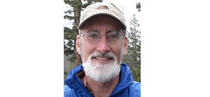 John Gross Man in a white hat wearing a blue jacket