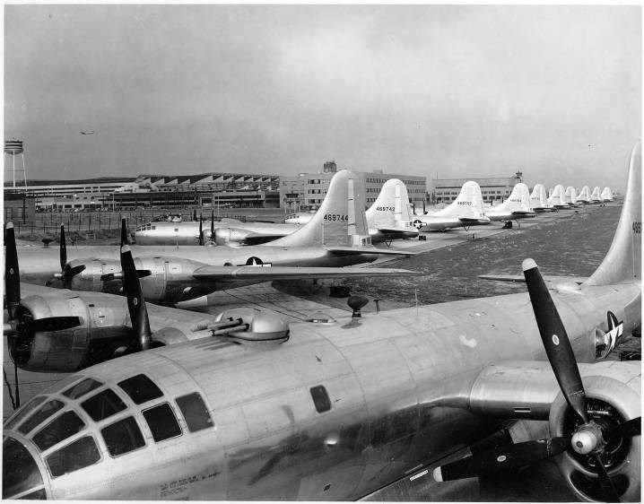 Boeing B19 Superfortresses, 1945 Black and white phot oof propeller planes in a row with a large one facing the camera in the foreground