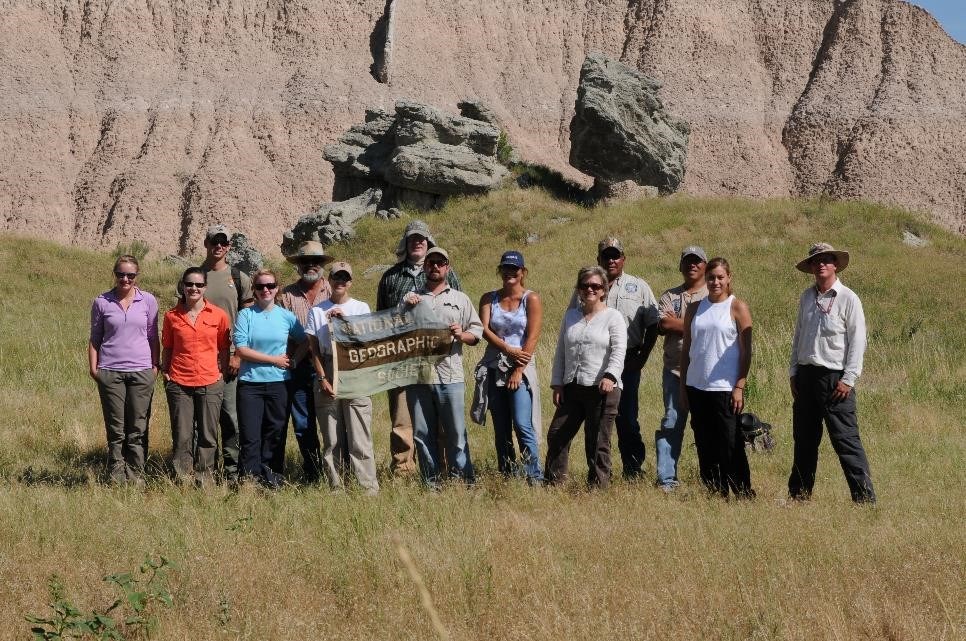 group of people gathered together in badlands area