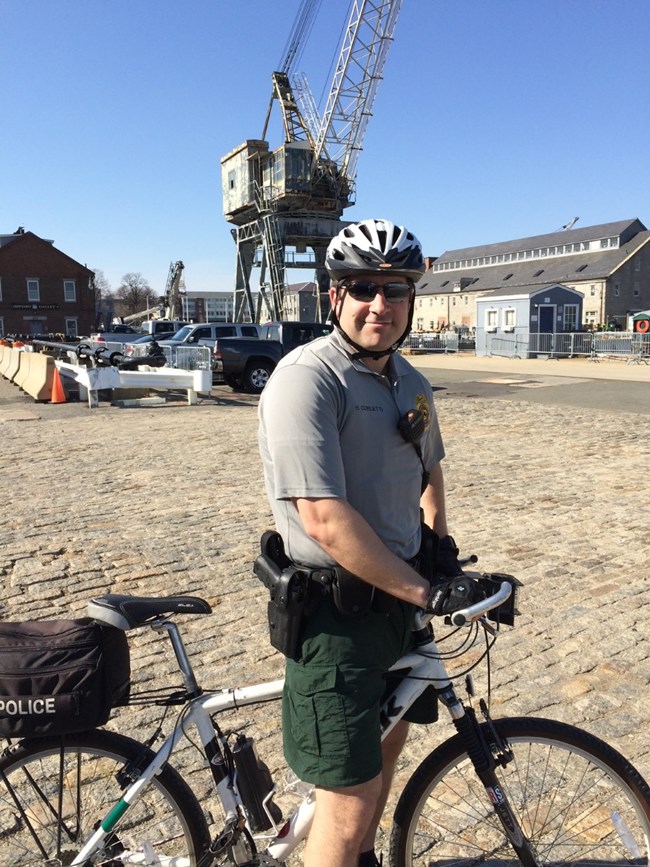 Henry patrolling in Boston on bike. A park ranger on a bike