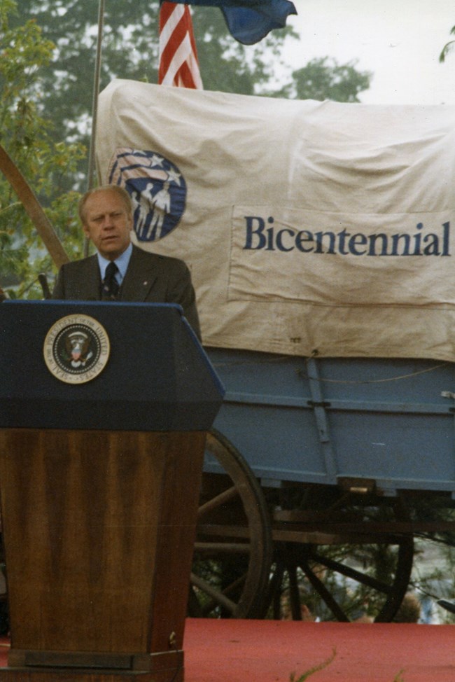 President Ford stands at a podium with a presidentail seal