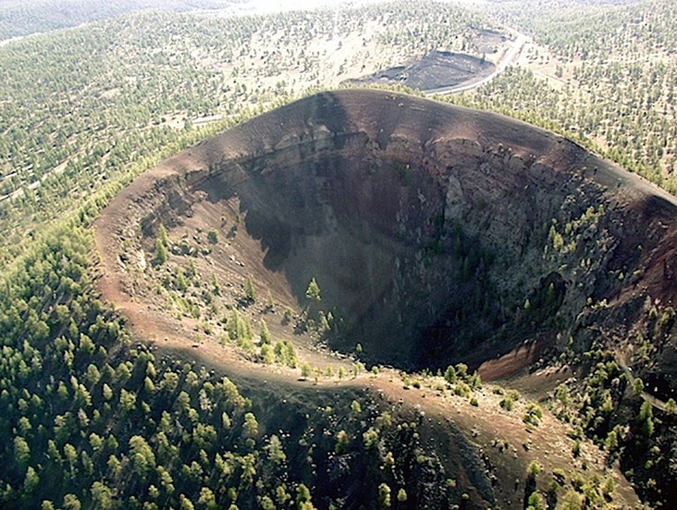 aerial photograph of a cinder cone with a summit crater