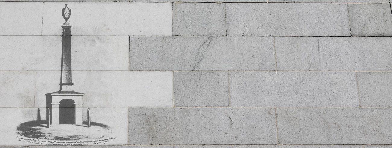 Living Memory banner Photo of granite blocks with a historic image of a historic monument overlayed on several of the blocks.