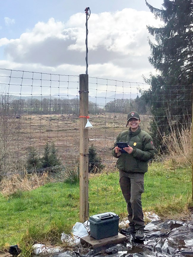 NPS staff standing next to a very tall pole with a microphone at the top.