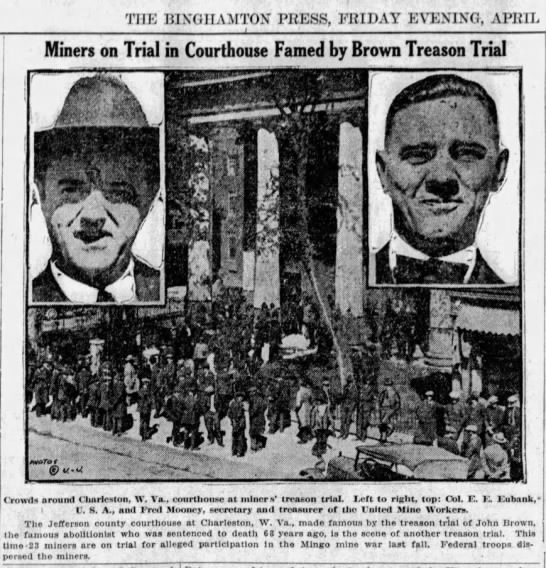 Newspaper clipping showing photograph portraits of two men with an image of a large porticoed building in between them. A headline above the images reads Miners on Trial in Courthouse Famed by Brown Treason Trial.