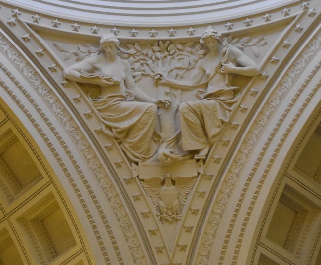 White granite pendentive architecture of two allegorical women
