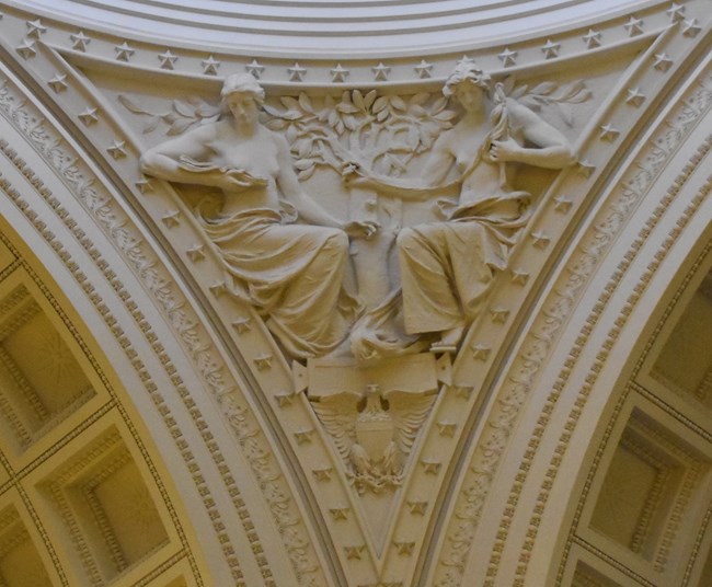 White granite pendentive architecture of two allegorical women