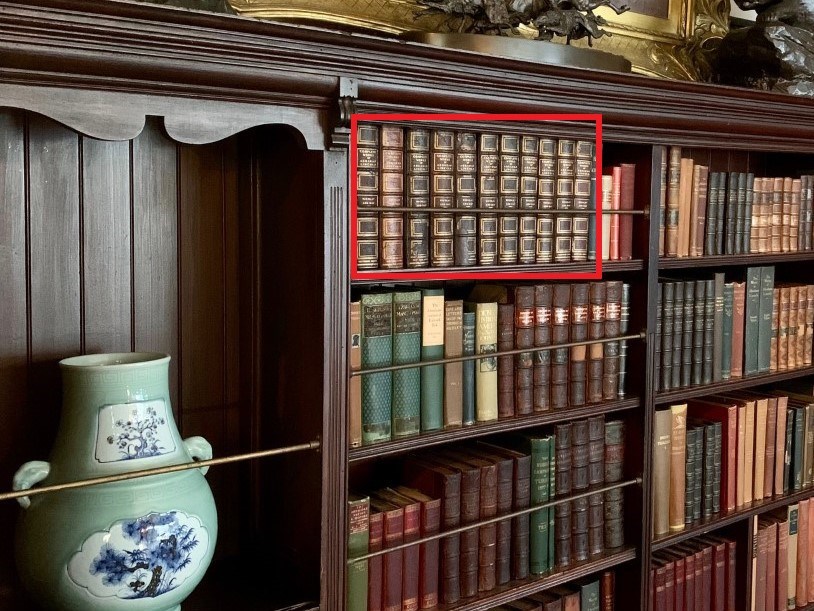 Photo of bookcase with historic books in Theodore Roosevelts' Library, red box around the set of books that was conserved