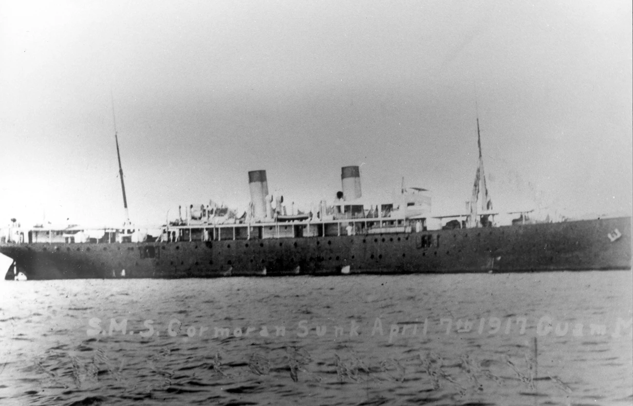 The S.M.S. Cormoran in Apra Harbor on April 7th, 1917. A large ship with two smokestacks and two masts.