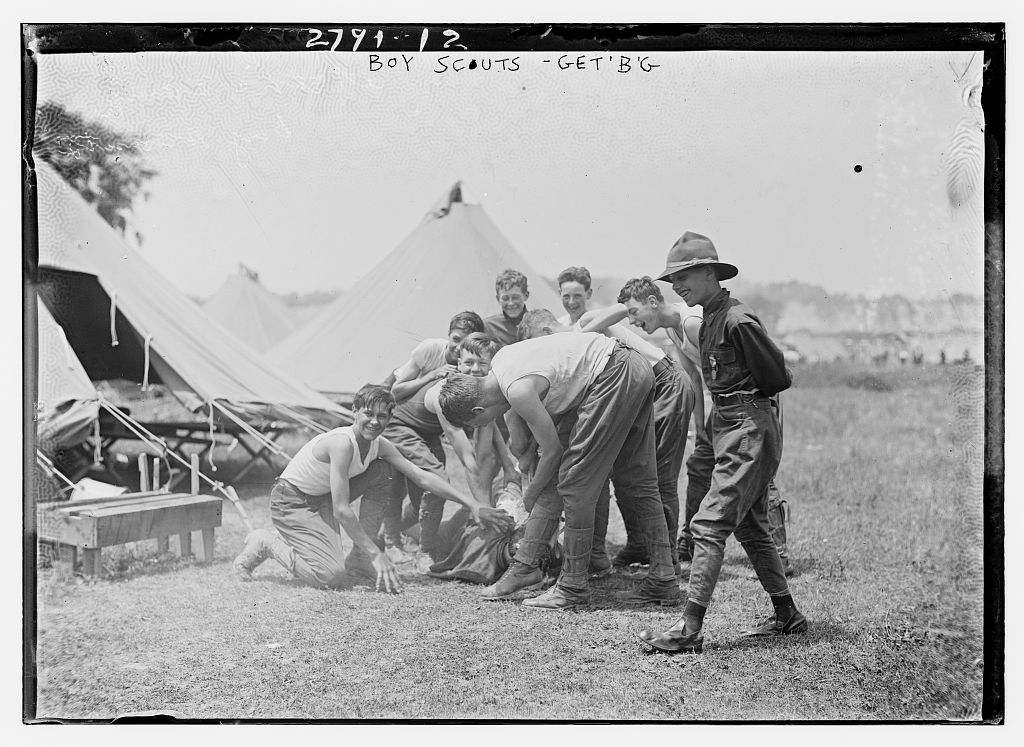 Young teenage boys playing outside of tents