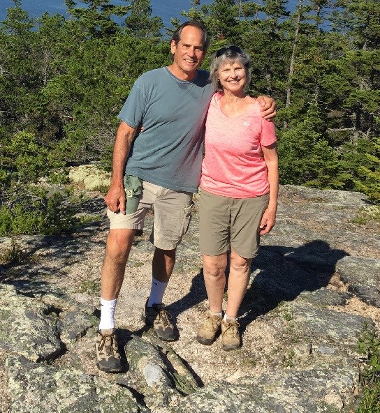 Brian Houseal two people stand on a rock in a forested area