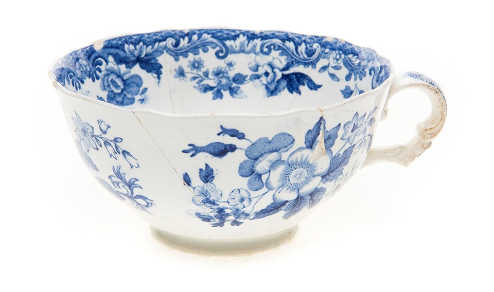British Flowers cup White ceramic teacup with a blue floral transfer printed pattern.