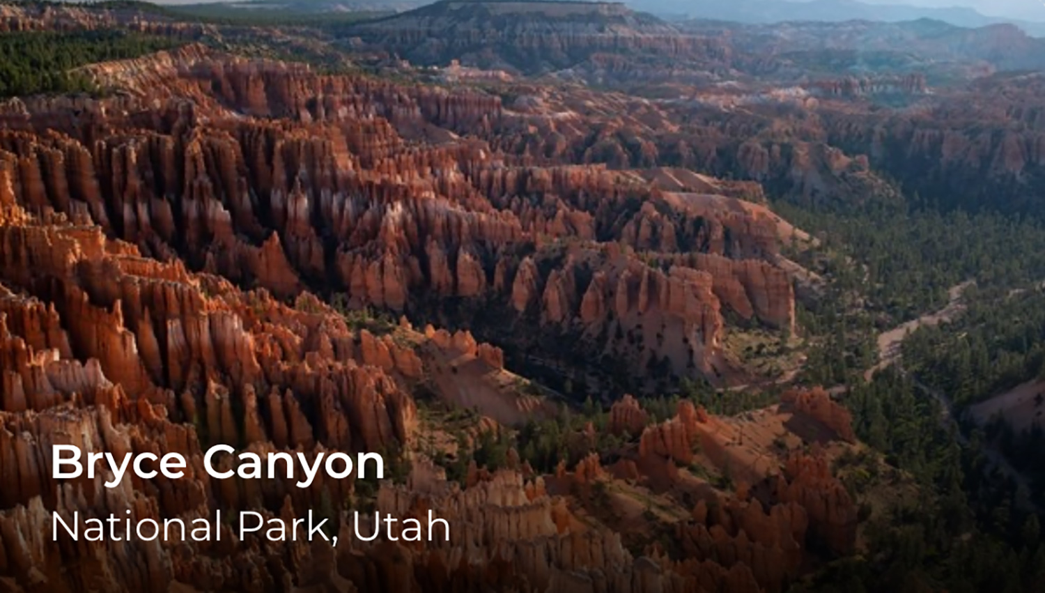 Red rocks create a canyon. In the lower left corner, the words Bryce Canyon.