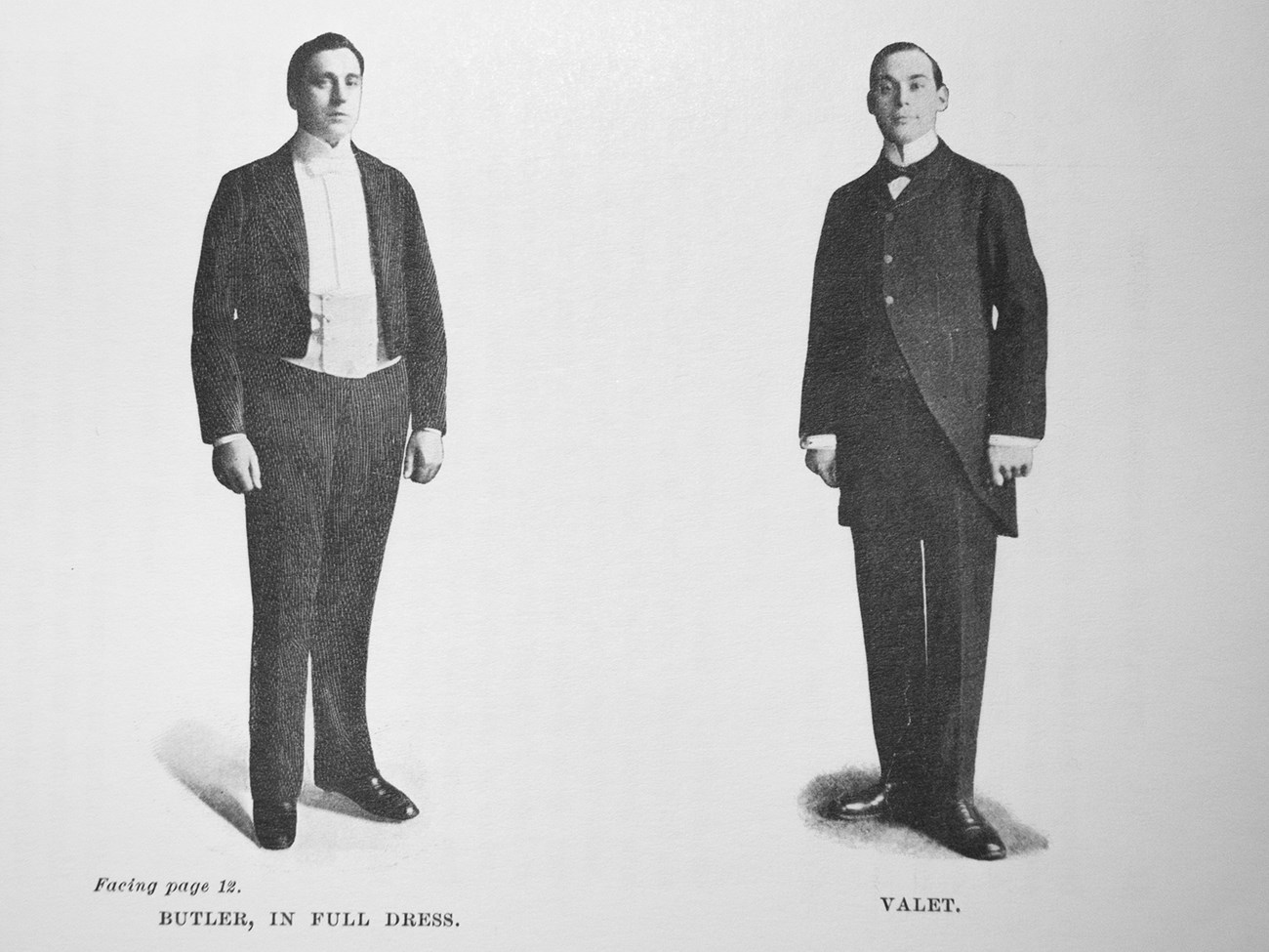 lt= A photograph of two men, a butler and a valet, in formal suits.