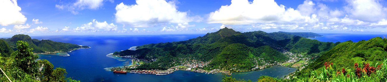 photo of a tropical harbor with steep, mountainous points of land