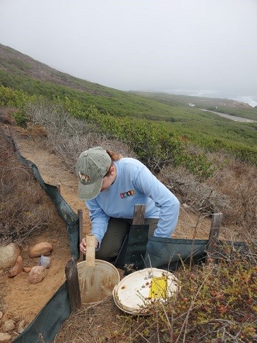 woman collecting data from a bucket