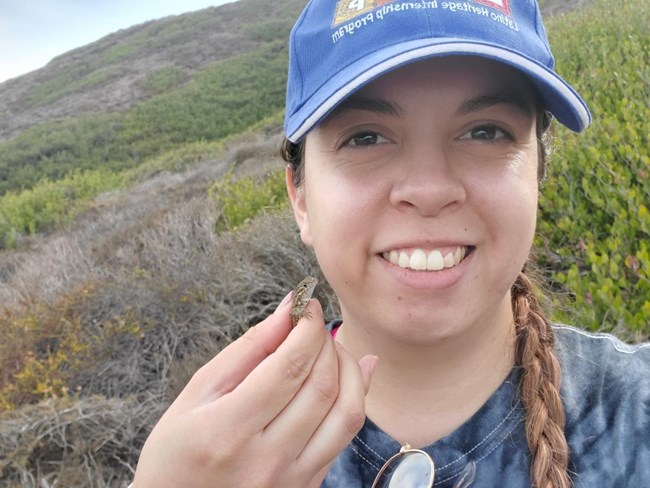 woman holding a lizard for a selfie