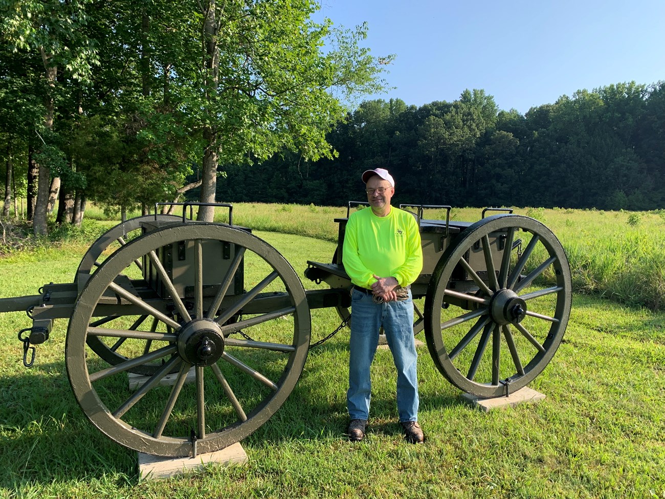 Calvin, Maintenance Volunteer, July 2023 Calvin, volunteer, standing outside int front of a cannon limber.
