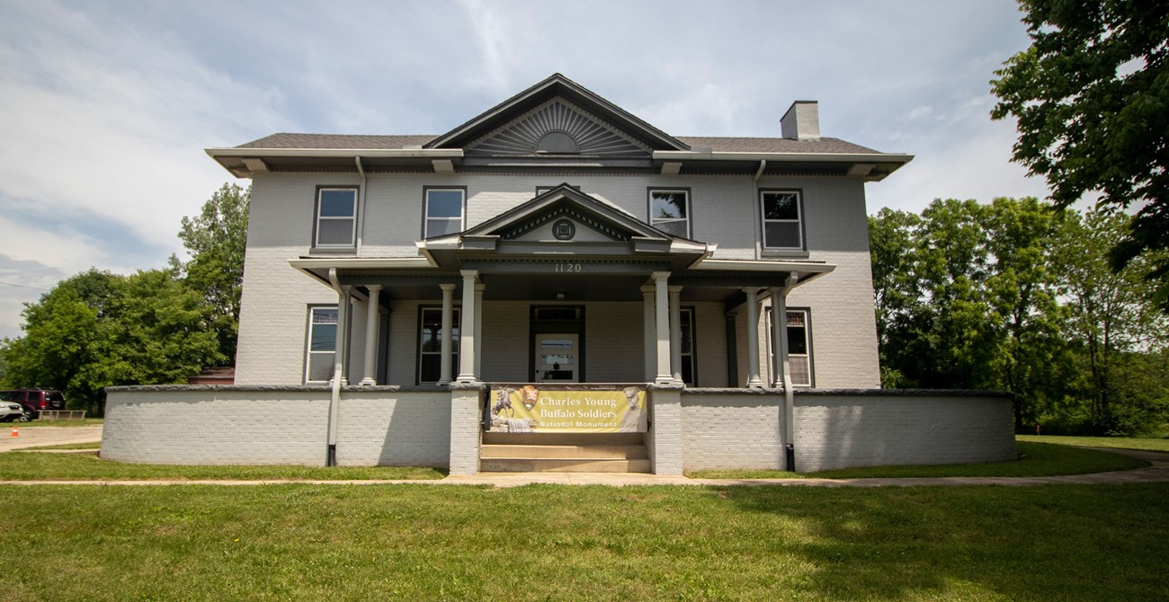 Two-story white house on a large lawn