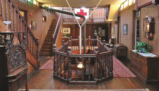 Interior of a historic home with a prominent interior balcony