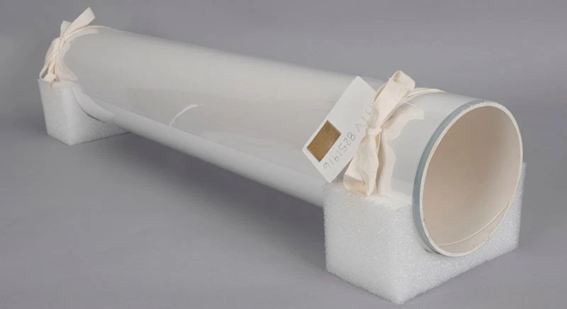 Completed roll tied with twill tape on each end, on polyethylene foam cradle mount ready for storage. Note label on one end.