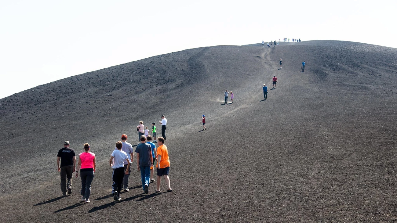 CRMO inferno cone D20566D0-AF4A-CE93-686CC1B3EA08EDA7 photo of groups of people walking on a barren scoria slope